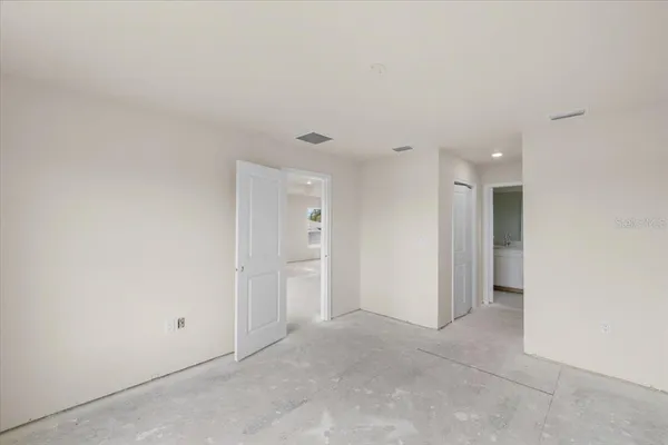 a view of a small space with wooden floor and a window