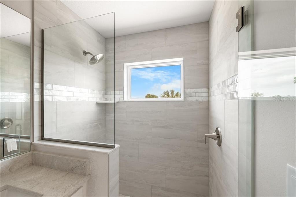 3498 Centavo Court Hernando Beach, FL 34607 - Photo 18 of 44 a bathroom with a glass shower door