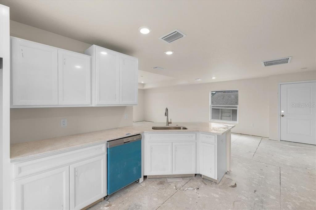 3498 Centavo Court Hernando Beach, FL 34607 - Photo 20 of 44 a kitchen with a sink and cabinets