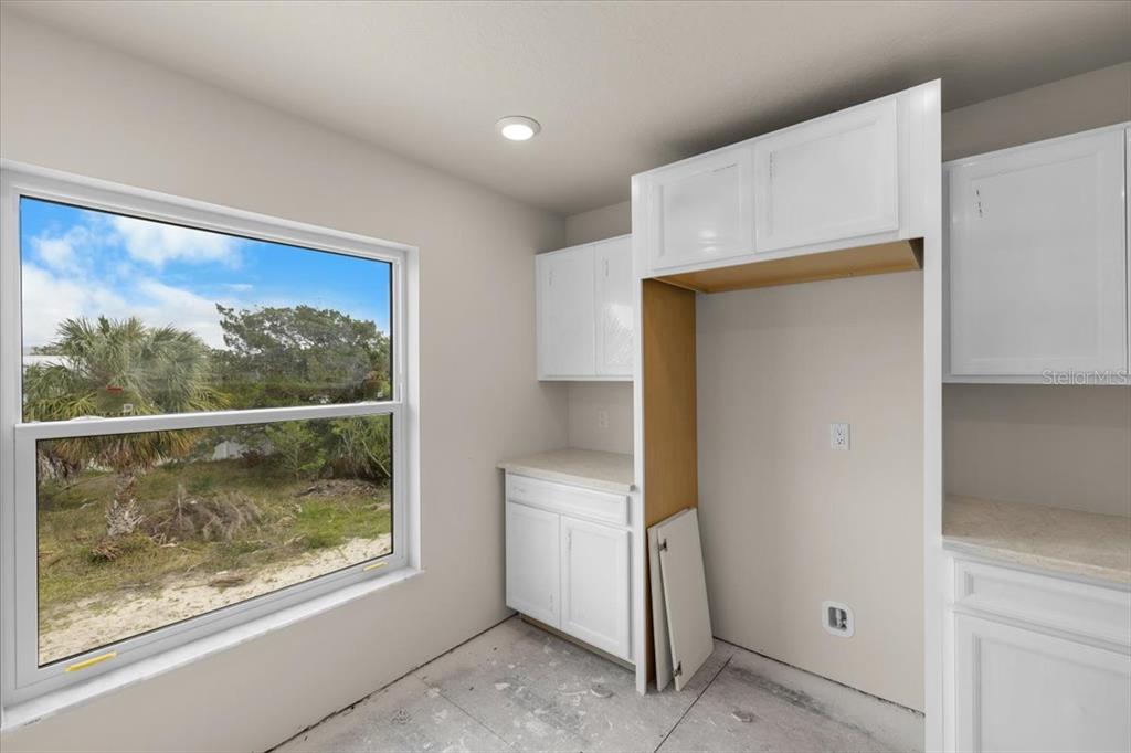 3498 Centavo Court Hernando Beach, FL 34607 - Photo 21 of 44 a view of a small space with wooden floor and a window