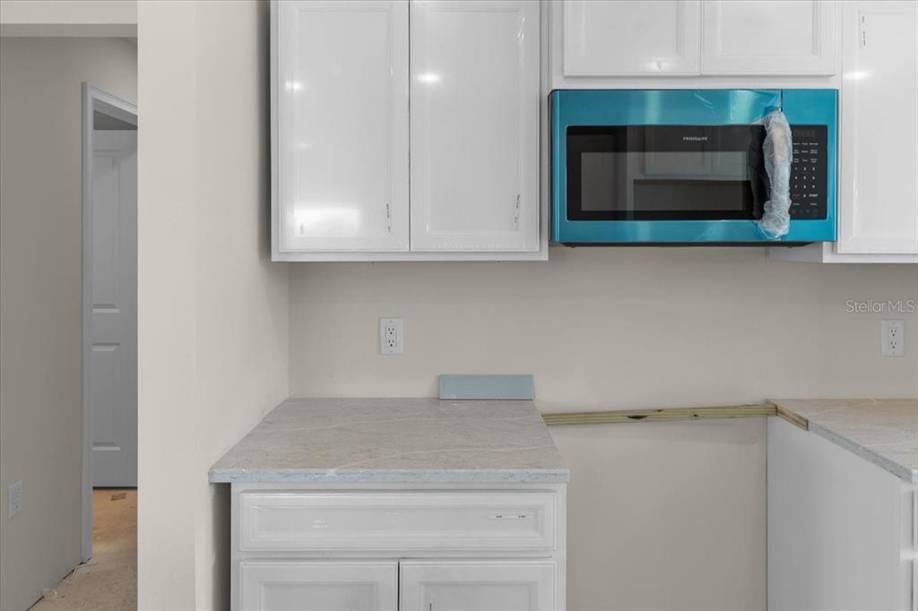 3498 Centavo Court Hernando Beach, FL 34607 - Photo 22 of 44 a kitchen with a sink and a microwave