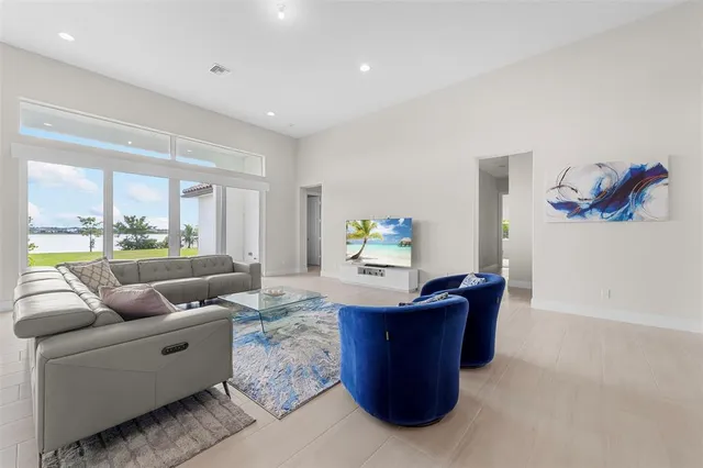 a room with furniture and view of kitchen