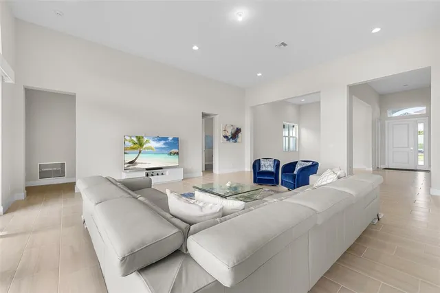 a large white kitchen with stainless steel appliances