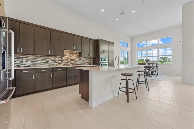 a large kitchen with stainless steel appliances and a sink