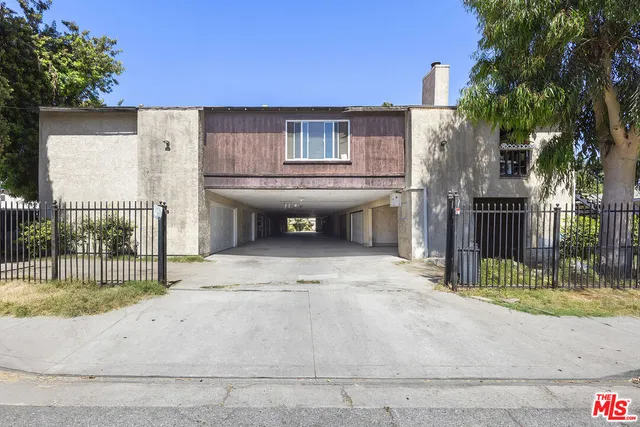 a view of a house with a wooden fence