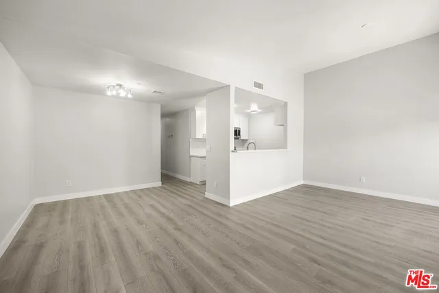 a view of a room with wooden floor