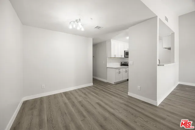a view of a kitchen with wooden floor and a kitchen