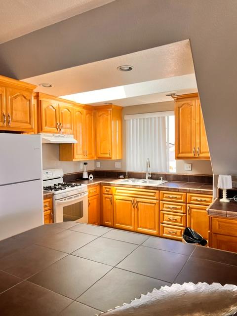 3019 Lathrop Road Manteca, CA 95336 - Photo 28 of 43 a kitchen with stainless steel appliances granite countertop a stove a sink and a microwave