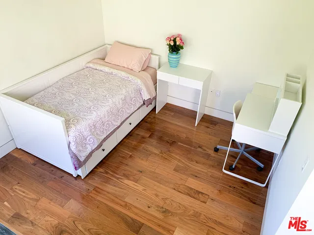 a bedroom with a bed and a chair