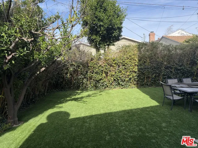 a view of a backyard with plants and a garden