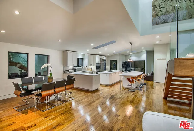 a living room with dining room and kitchen view