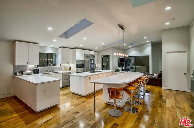 a large kitchen with a table and chairs