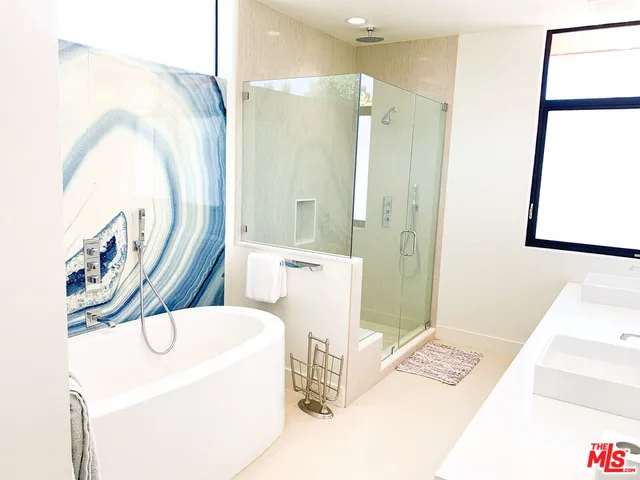 a bathroom with a sink a mirror and a shower