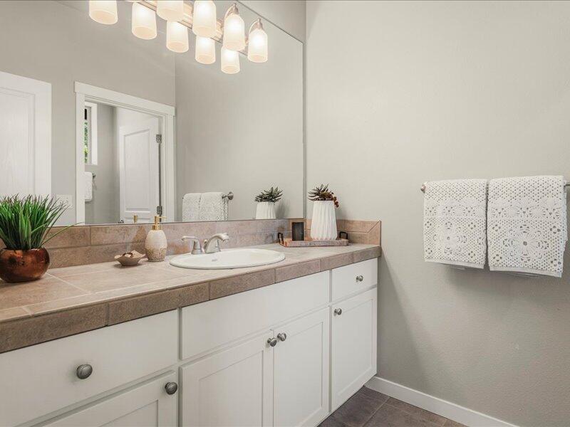 1378 Highland View Loop Redmond, OR 97756 - Photo 40 of 98 a bathroom with a granite countertop sink and a mirror