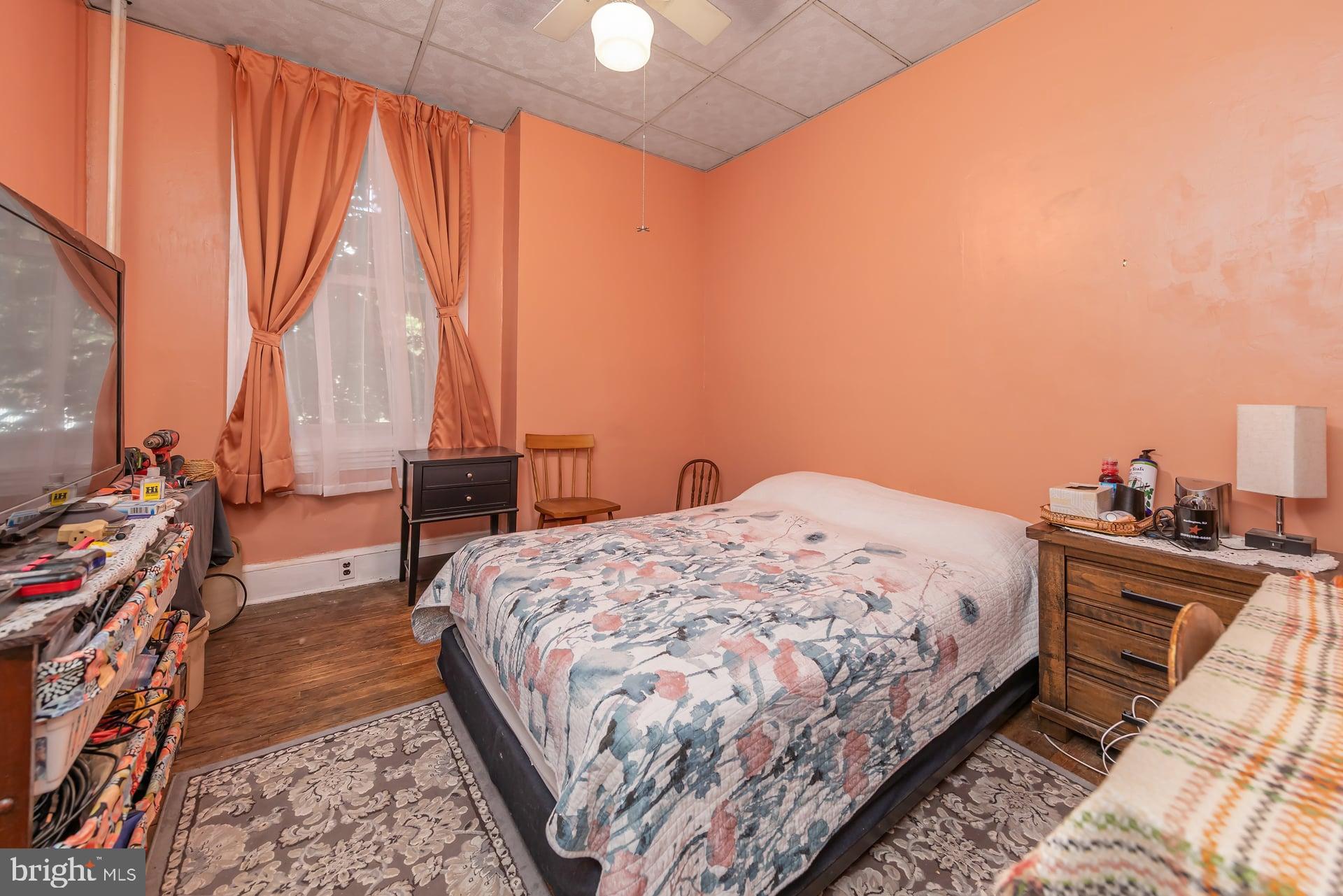 401 West Avenue Delanco, NJ 08075 - Photo 9 of 19 a bedroom with a bed and a flat tv screen on the dresser