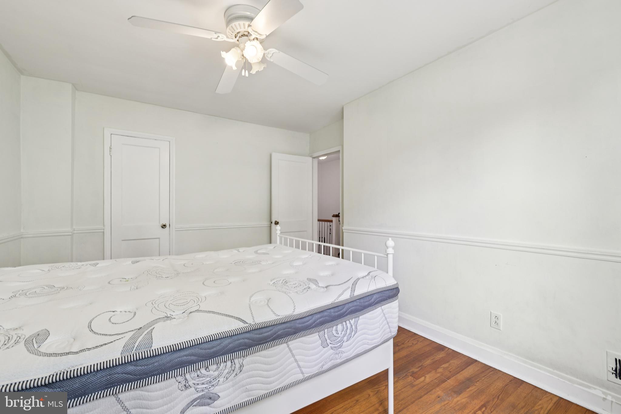 130 Dumbarton Road Baltimore, MD 21212 - Photo 19 of 34 a bedroom with a bed and a ceiling fan