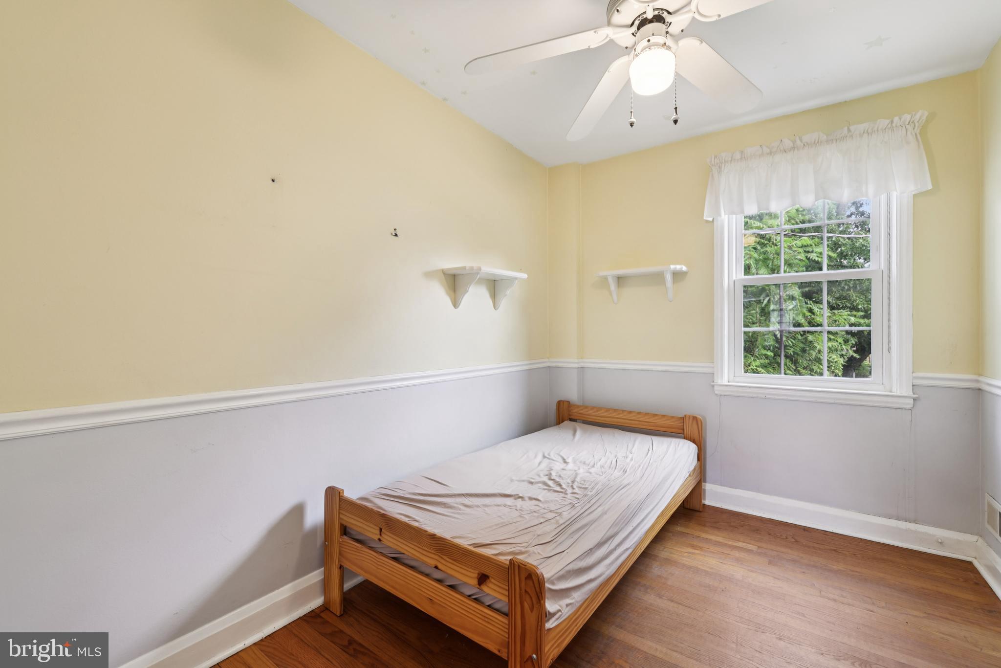 130 Dumbarton Road Baltimore, MD 21212 - Photo 20 of 34 a bedroom with a bed and window
