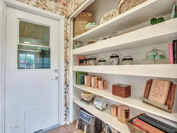 a shelf with books and knick knacks on it