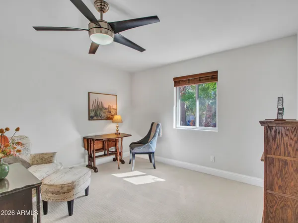 a living room with furniture and a book shelf