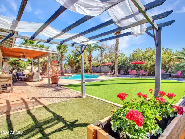 a front view of a house with fountain and potted plants