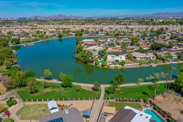 an aerial view of a houses with outdoor space lake view and mountain view