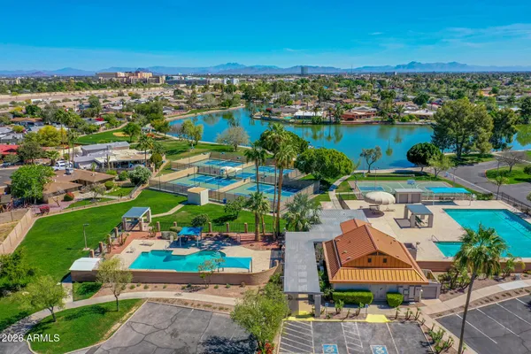 an aerial view of a house with a garden and lake view