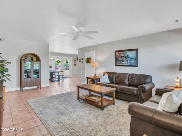 a living room with furniture and a potted plant