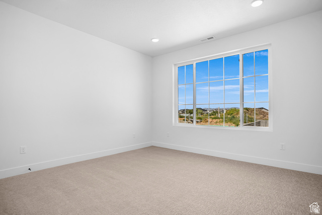 1631 West Century Lane, Unit C Mapleton, UT 84664 - Photo 15 of 31 Spacious room featuring a large multi-pane window, recessed lighting, neutral carpeting, and crisp white baseboards