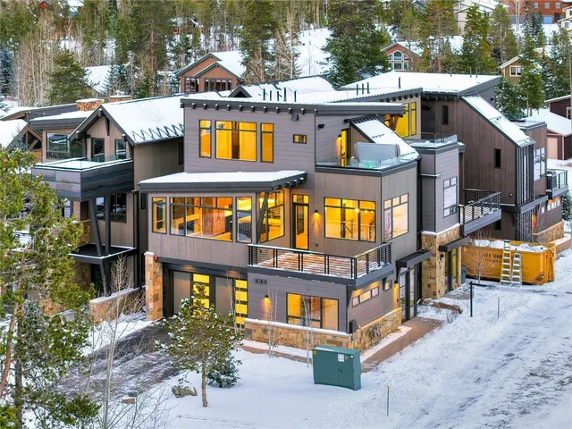 an aerial view of multi story residential apartment building with a yard