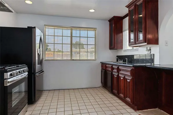 a kitchen with stainless steel appliances a stove a sink and a microwave