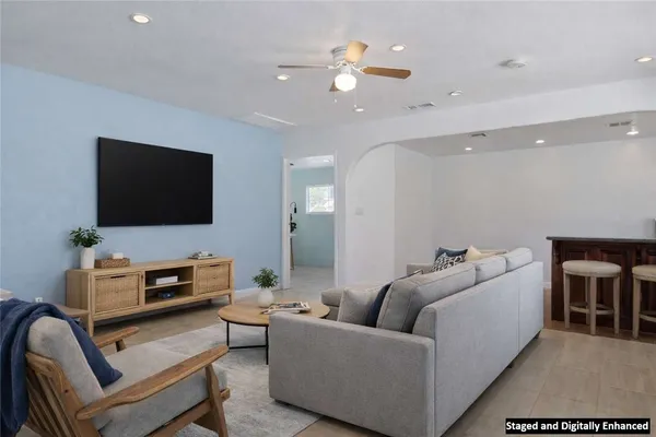 a spacious bedroom with a bed and a couch
