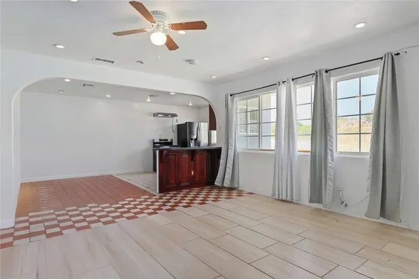 a view of kitchen with furniture and a ceiling fan