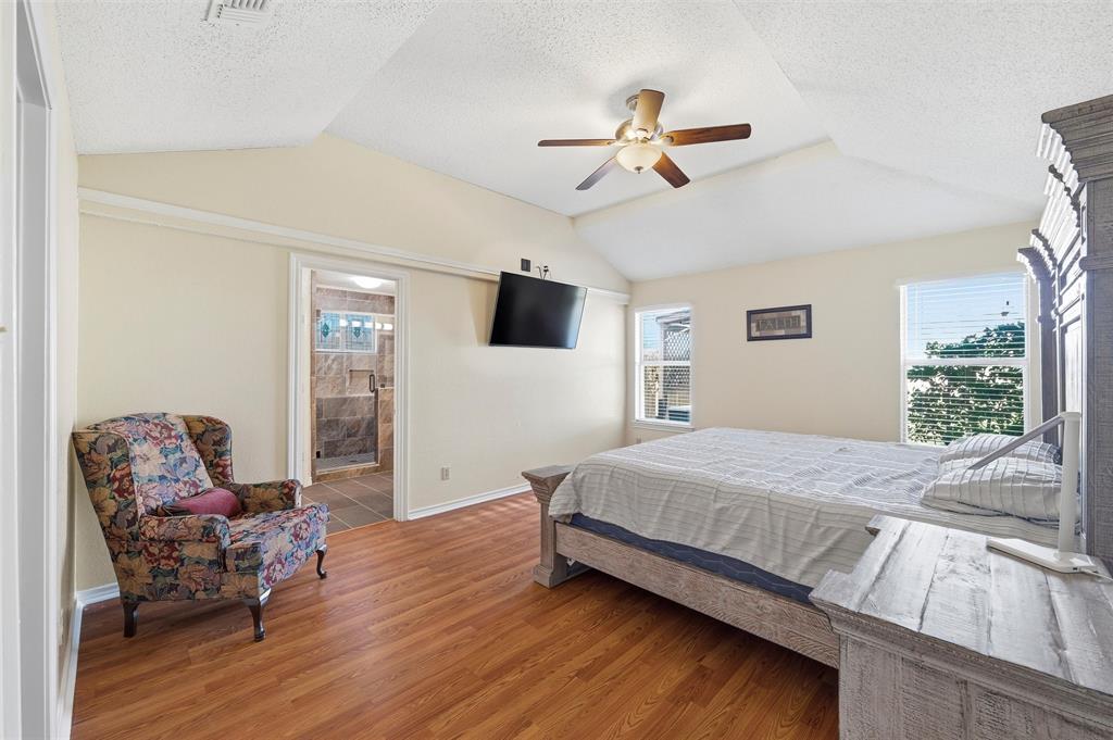 517 Hiwasee Road Waxahachie, TX 75165 - Photo 15 of 38 a bedroom with a bed and wooden floor