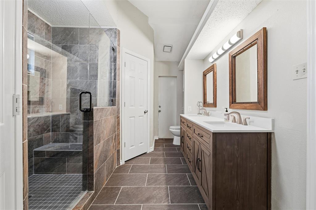 517 Hiwasee Road Waxahachie, TX 75165 - Photo 17 of 38 a bathroom with a double vanity sink mirror and shower