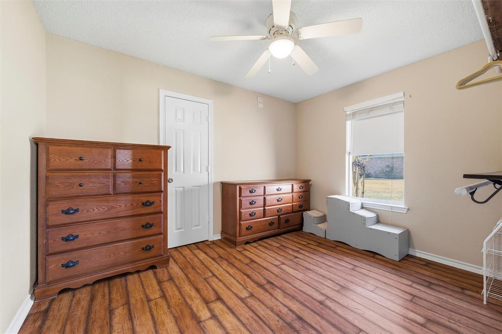 517 Hiwasee Road Waxahachie, TX 75165 - Photo 22 of 38 a view of a bedroom with furniture window and wooden floor