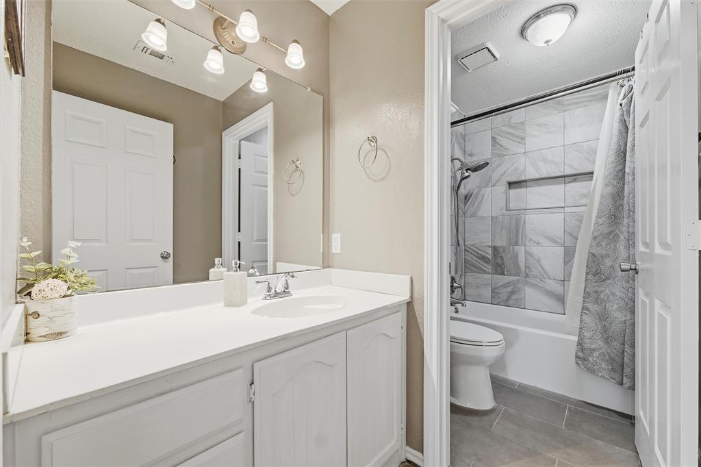 517 Hiwasee Road Waxahachie, TX 75165 - Photo 23 of 38 a bathroom with a sink a toilet and shower