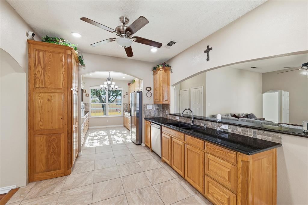 517 Hiwasee Road Waxahachie, TX 75165 - Photo 8 of 38 a large kitchen with stainless steel appliances a sink and cabinets