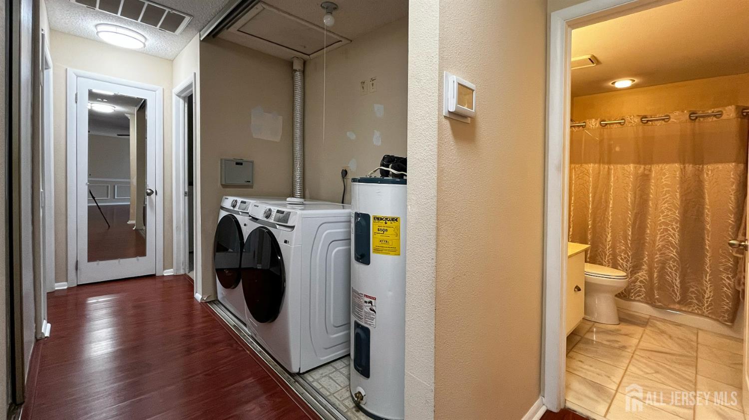 719 Delair Road, Unit B Monroe Township, NJ 08831 - Photo 8 of 21 a view of a hallway with washer and dryer