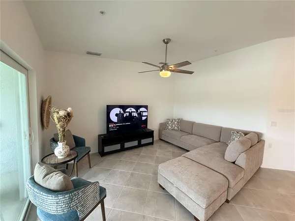 a living room with furniture and a flat screen tv