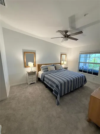 a bedroom with a bed and ceiling fan