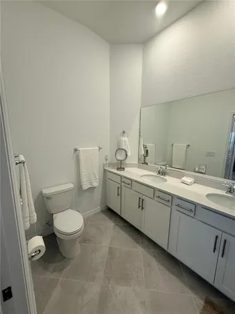 a bathroom with a double vanity sink and mirror
