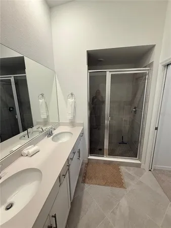 a bathroom with a double vanity sink a and mirror