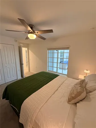 a bedroom with a large bed and a window