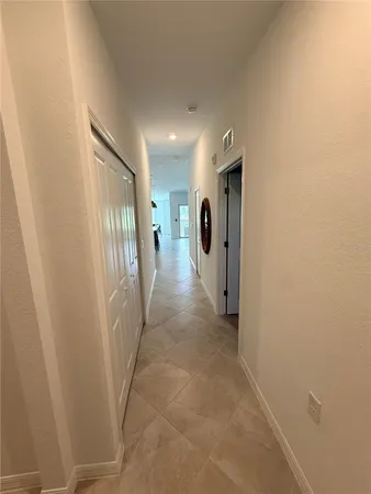 a view of a hallway with wooden shelves