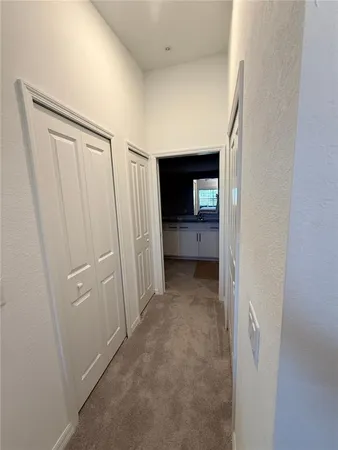 a view of a hallway to rooms