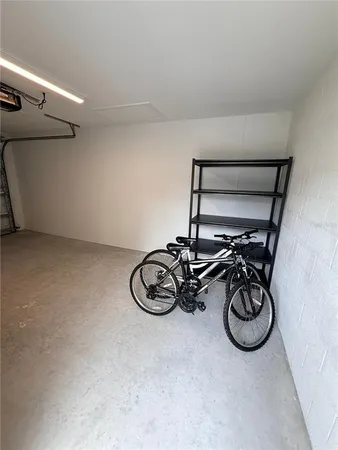 a view of a bike storage and utility room with racks on the wall