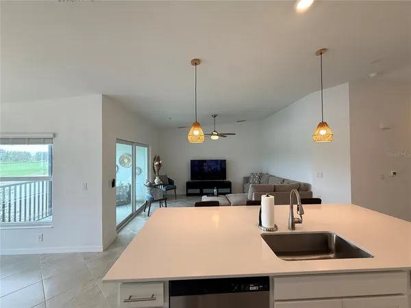 a kitchen with a sink a counter space and a fireplace