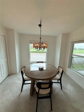 a dining room with furniture and window