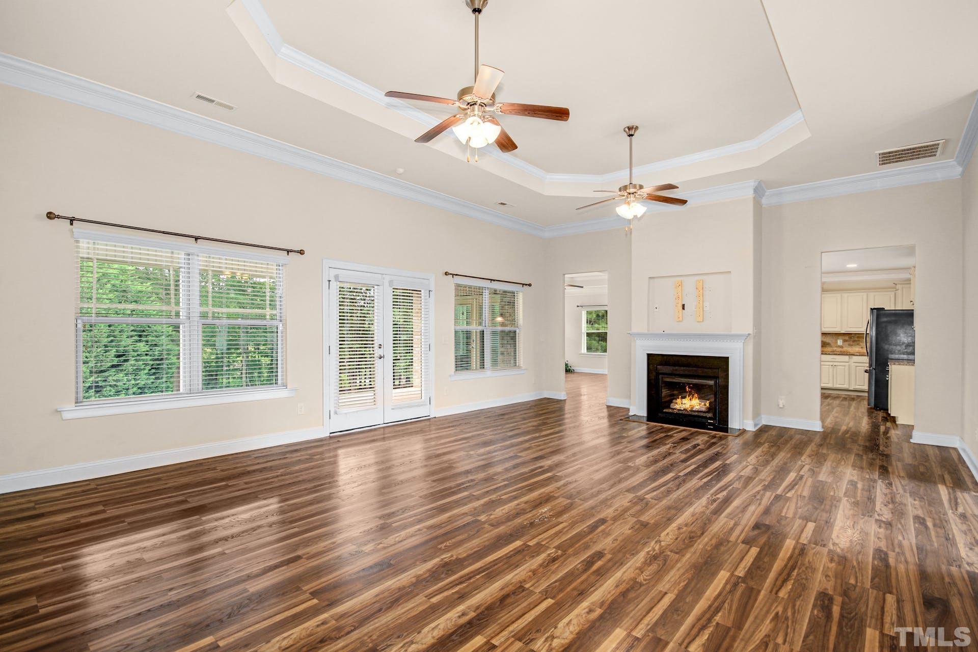 44 Destiny Circle Angier, NC 27501 - Photo 11 of 35 a view of an empty room with wooden floor fireplace and a window