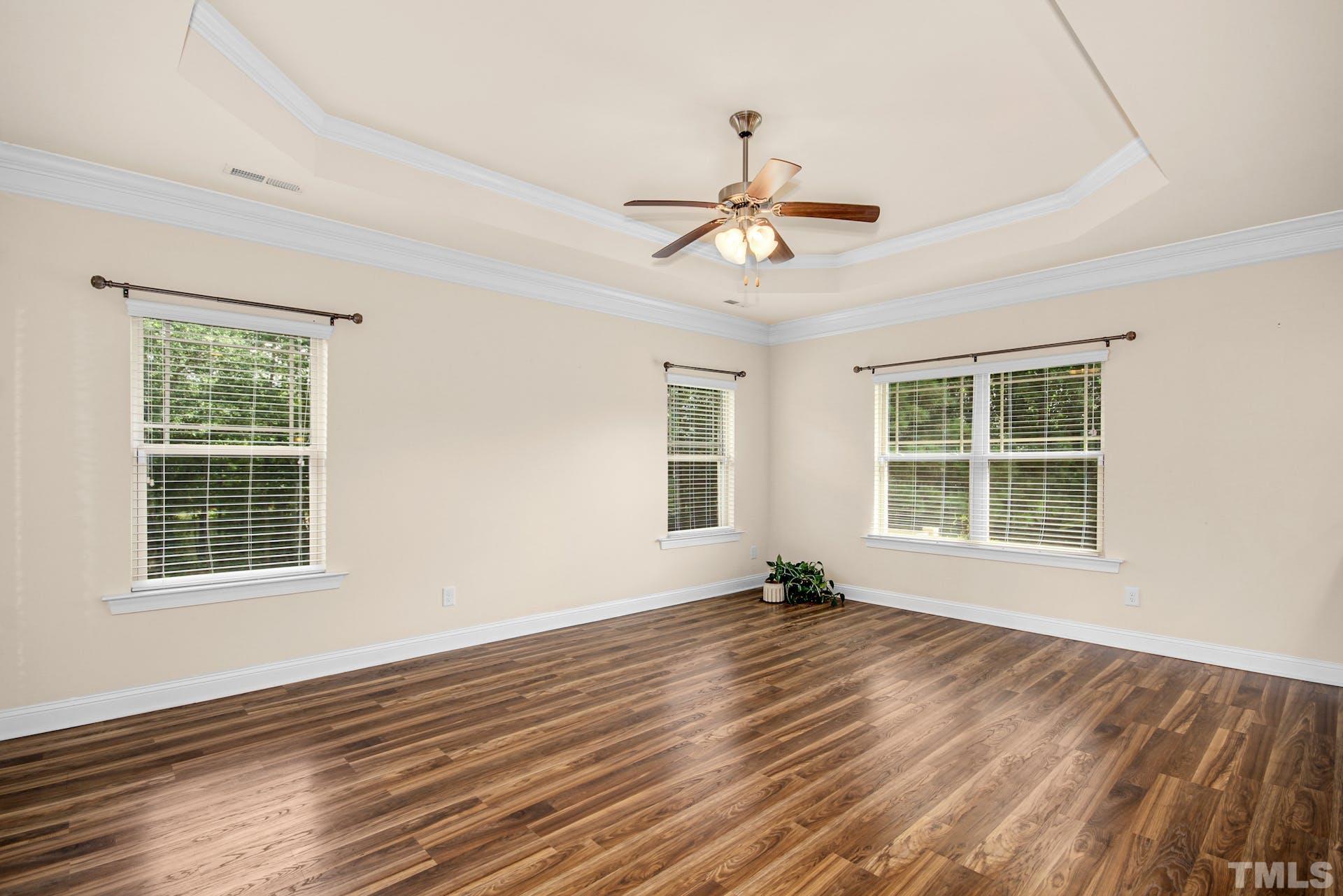 44 Destiny Circle Angier, NC 27501 - Photo 13 of 35 a view of an empty room with a window and wooden floor